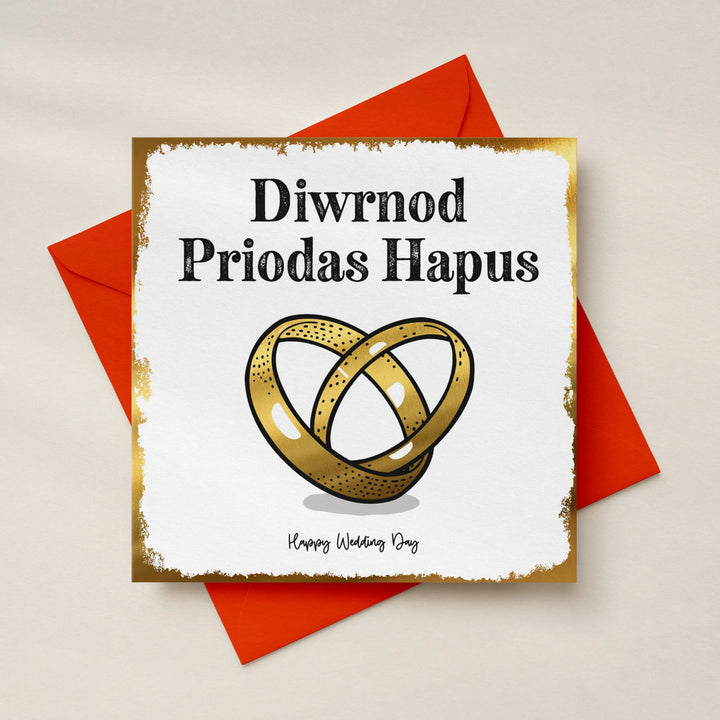 Bilingual Welsh wedding card with gold foil interlocking rings and 'Diwrnod Priodas Hapus' text at the top and 'Happy Wedding Day' text at the bottom.