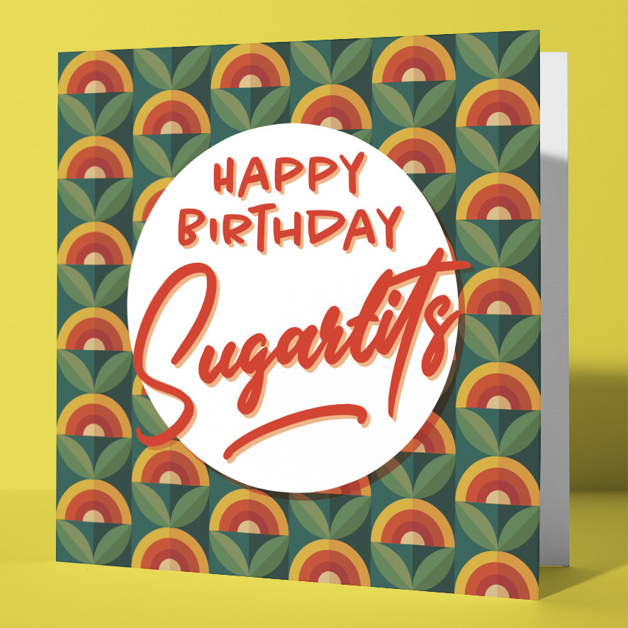 The Happy Birthday Sugartits Retro Floral Card features a square design with vibrant rainbow and leaf patterns. Bold red "Happy Birthday Sugar tits" text stands out on a white circle, perfect for funny birthday wishes.