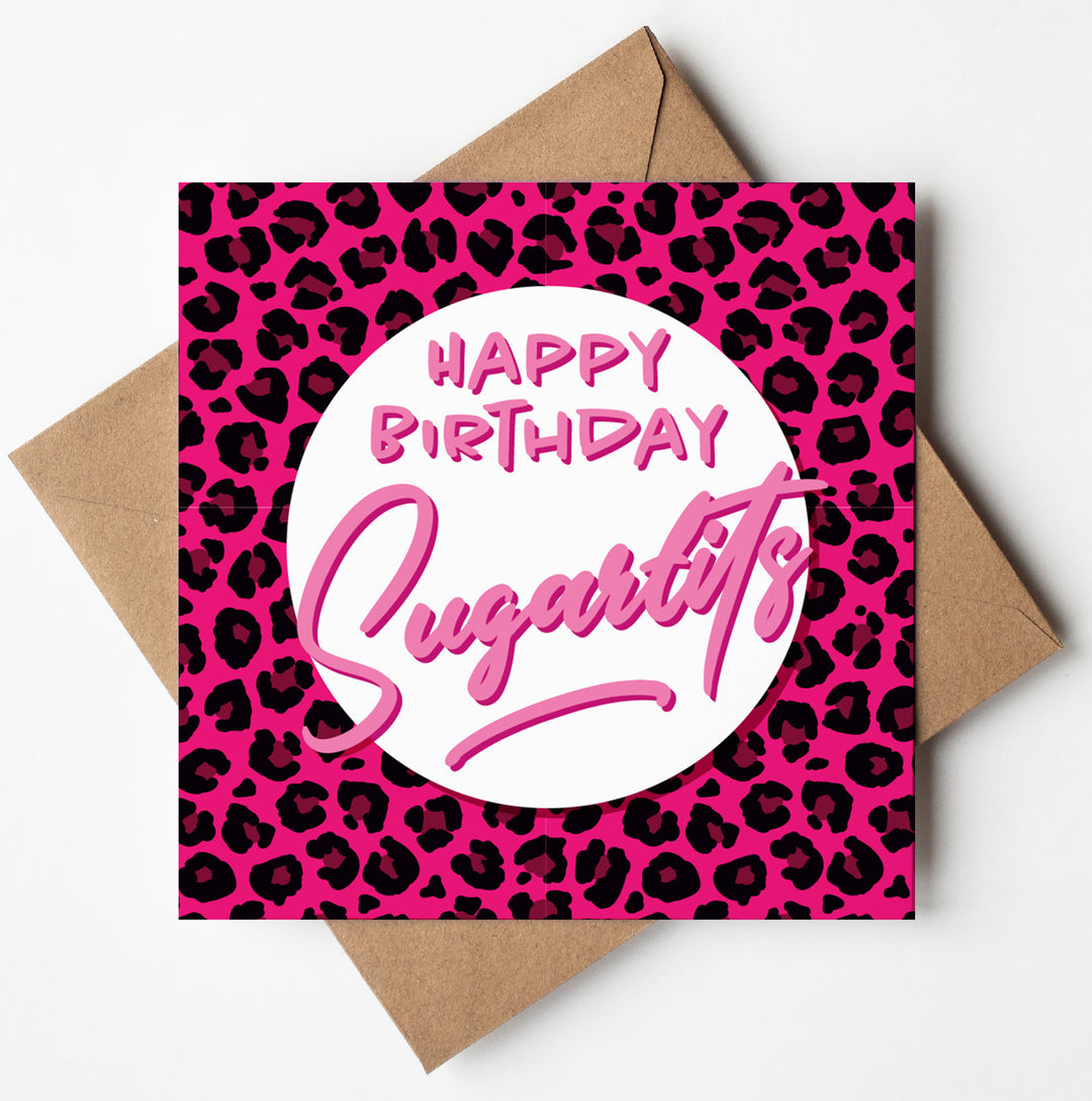 The "Happy Birthday Sugartits Pink Panther Card," designed in Wales, features a pink leopard print background with the phrase "Happy Birthday Sugar tits" in bold and playful fonts. It pairs beautifully with a brown envelope.