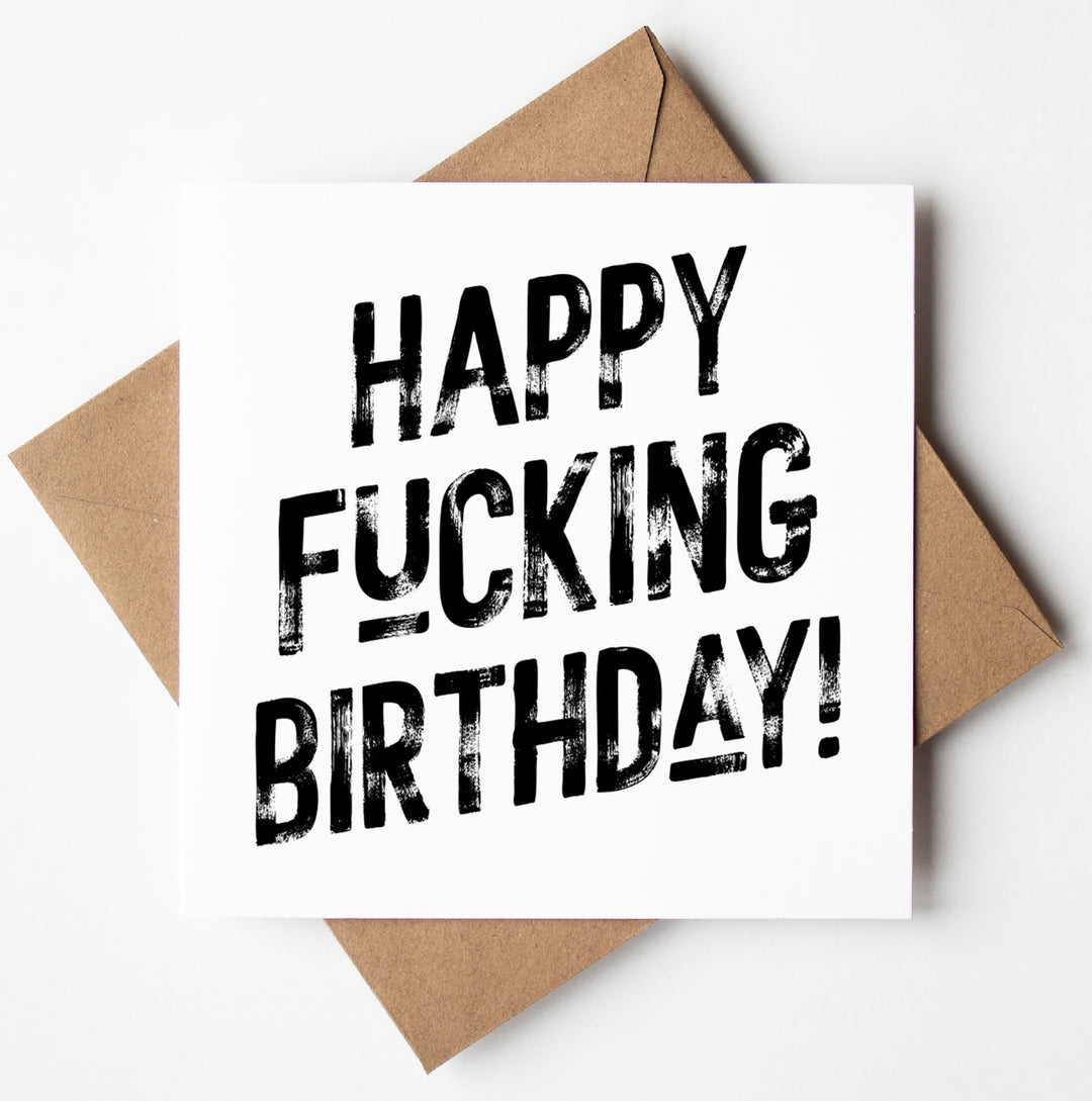 The "Happy Fucking Birthday! Harlem Card" features bold, distressed black text on a white background, reading "Happy Fucking Birthday!" and is displayed atop a brown envelope.