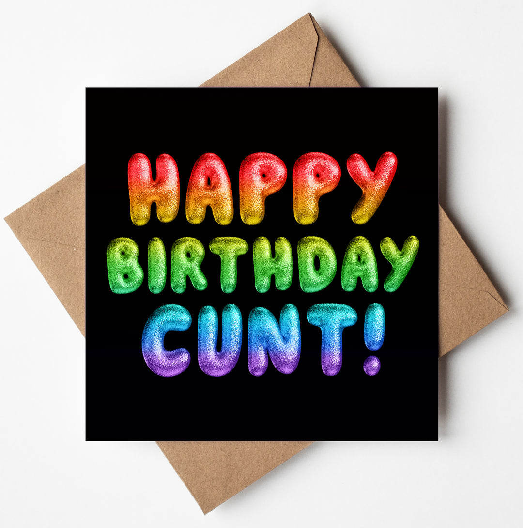 The "Happy Birthday Cunt! Rainbow Font Card" features colorful, balloon-like letters spelling "HAPPY BIRTHDAY" and "CUNT!" in a vibrant rainbow font against a black background, accompanied by a brown envelope.