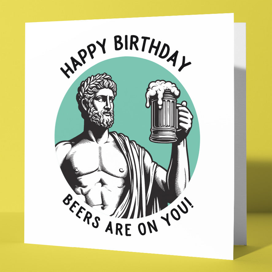 The "Happy Birthday. Beers Are On You! Statue Dude Card" features a toga-clad, statue-like man hoisting a frothy beer with "HAPPY BIRTHDAY" above and "BEERS ARE ON YOU!" below on a charming teal background.