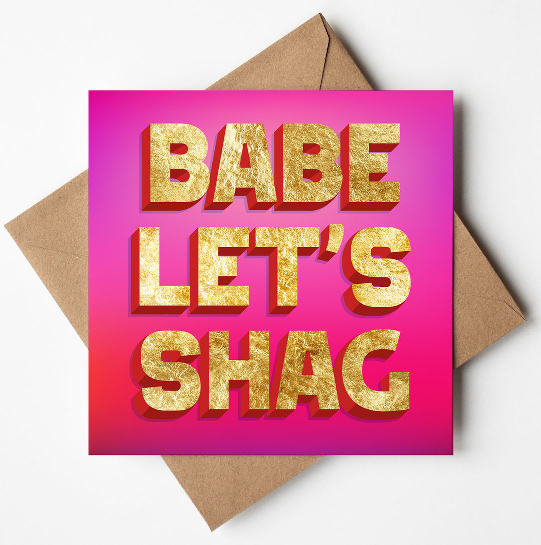 The "Babe Let's Shag Love Card" features a humorous design with a pink background and bold, gold-textured letters. This cheeky, minimalist Valentine's Day card comes with a brown envelope.