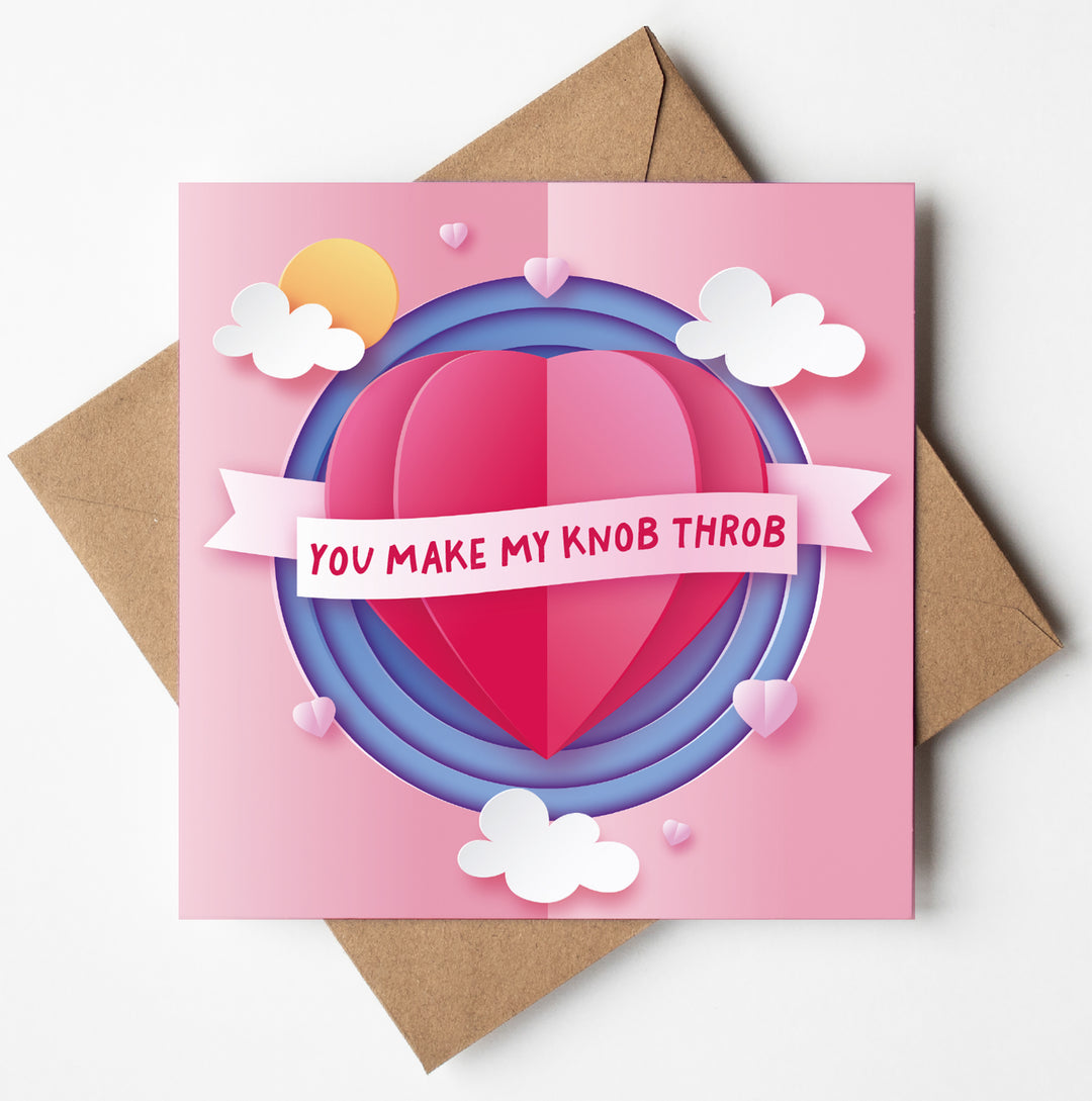 A humorous Valentine's card named "You Make My Knob Throb," showcasing a layered heart design with clouds and sun on a pink and purple backdrop, paired with a brown envelope.