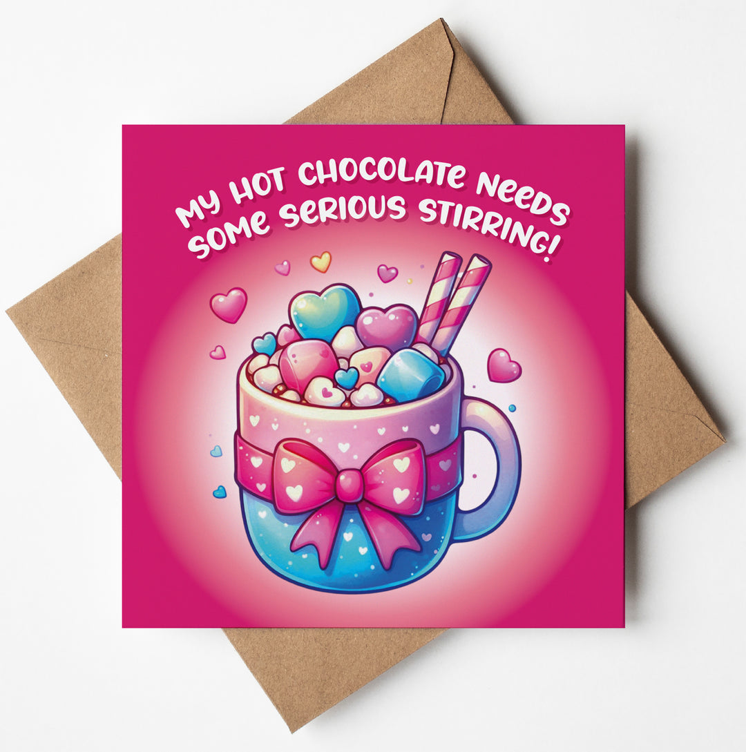 Valentine's card featuring a pink backdrop with a hot chocolate mug decorated with hearts and bow, topped with marshmallows, hearts, and striped straws. Reads "My Hot Chocolate Needs Some Serious Stirring!.