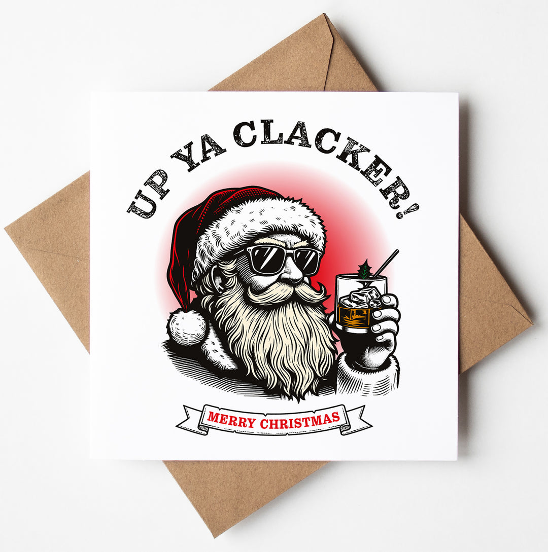 This "Up Ya Clacker! Aussie Merry Christmas Card" features a fun illustration of Santa sporting sunglasses and a Santa hat while holding a drink. The text above says "Up Ya Clacker!" and the banner below states "Aussie Merry Christmas." With its festive and humorous design, this card is shipped worldwide in a biodegradable bag and includes a brown envelope.