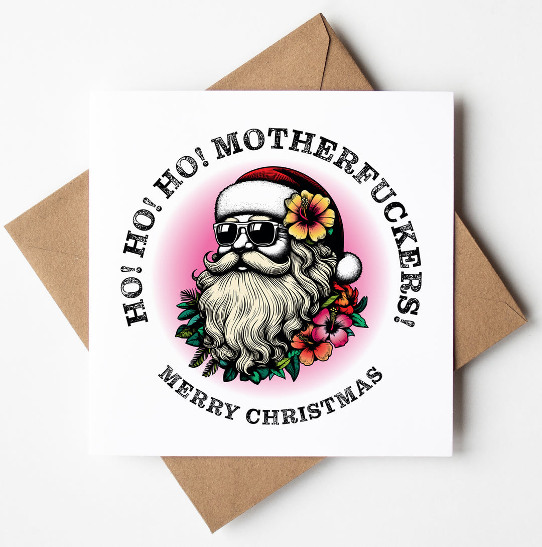 This humorous Christmas card, titled 'Sunglass Santa's Ho! Ho! Ho! Motherfuckers! Christmas Card,' showcases a stylized Santa Claus donning sunglasses and a red hat, surrounded by vibrant flowers. The card features the playful text "Ho! Ho! Ho! Motherfuckers! Merry Christmas" set against a pink and white background, offering a cheeky addition to your adult Xmas card collection.