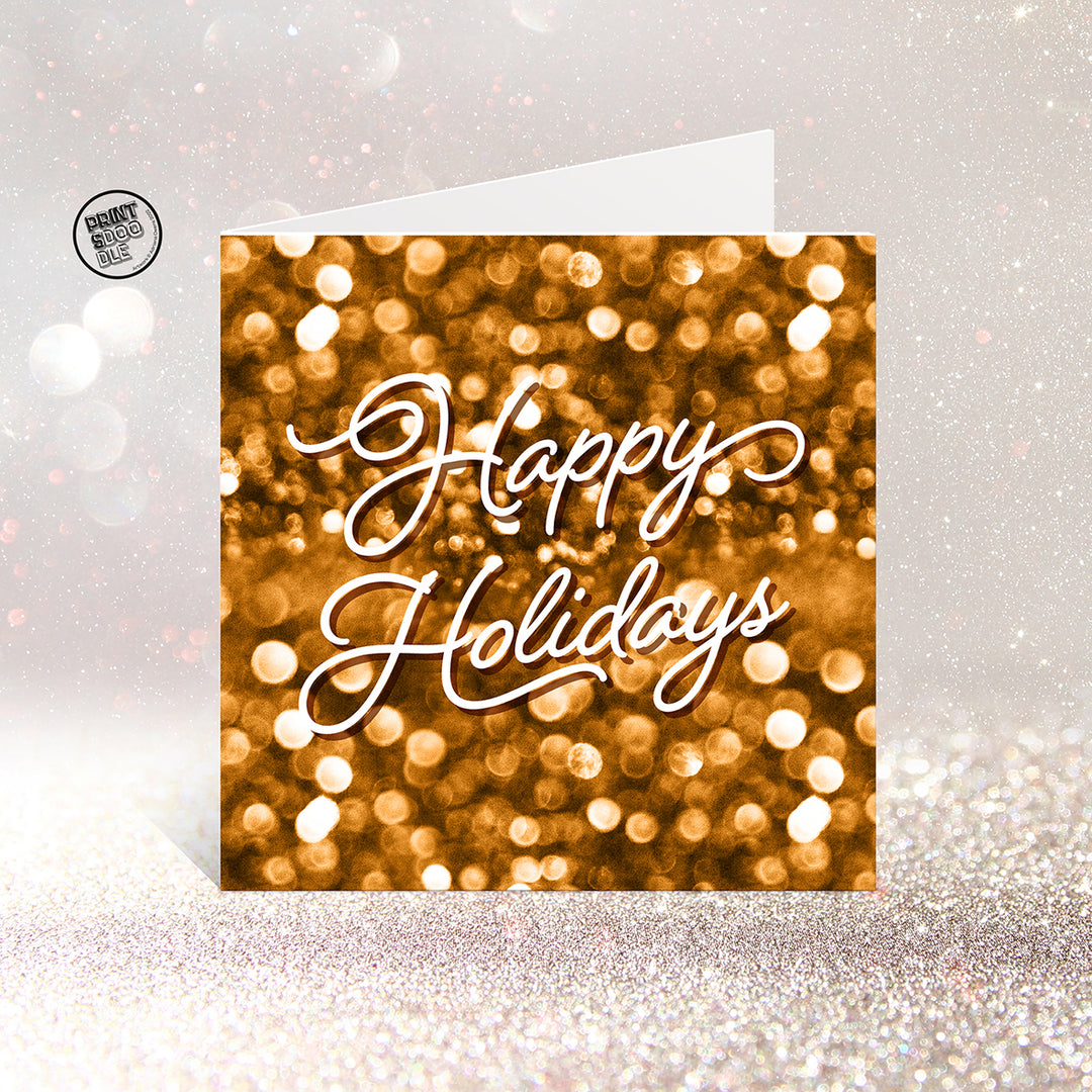The SALE! Happy Holidays Gorgeous Christmas Card features a gold glittery background with elegant white script, UK printed and packed in a biodegradable bag—perfect for a festive, eco-friendly greeting.