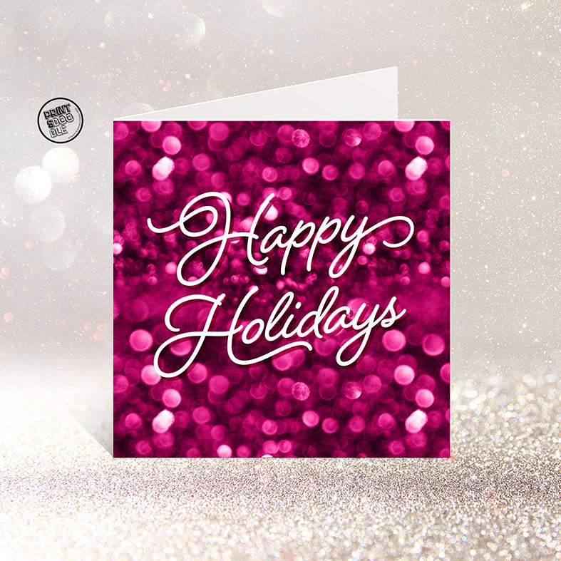 The SALE! Happy Holidays Gorgeous Christmas Card features a sparkling pink and magenta bokeh background with “Happy Holidays” in elegant white script. UK printed, it stands on a glittery surface and comes in a biodegradable bag.