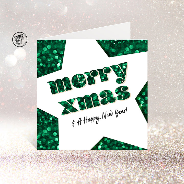 The SALE! Merry Xmas And A Happy New Year! Christmas Card features a large white star on green glitter, with "Merry xmas" and "& A Happy New Year!" inside. Packaged in a biodegradable bag and available for worldwide shipping.