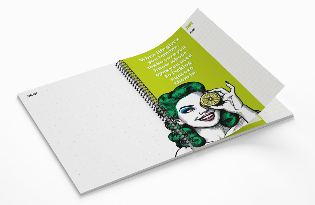 Notebook with a colorful illustration on the cover, featuring a woman with green hair and a lemon slice.