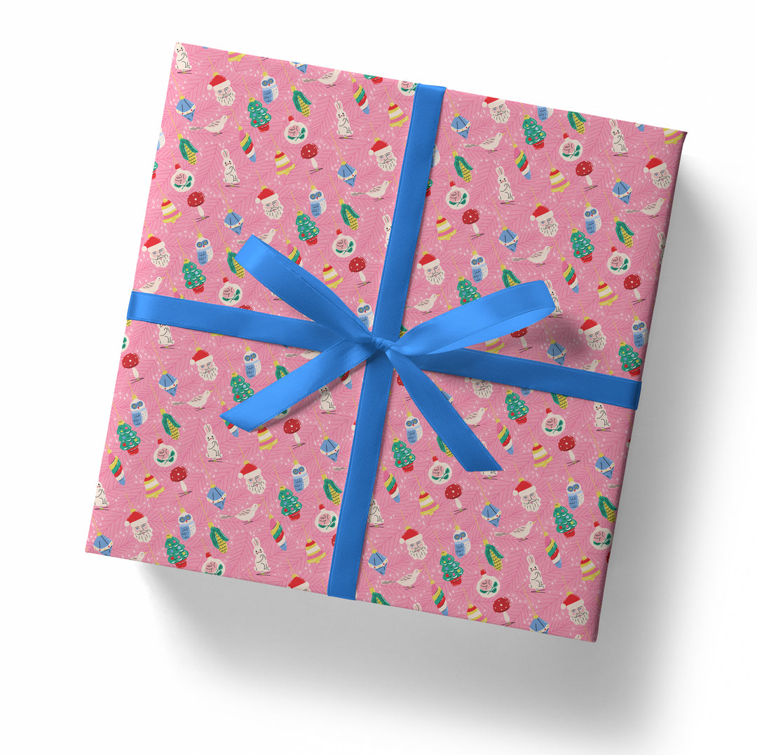 Gift box with pink patterned paper and blue ribbon on a white background