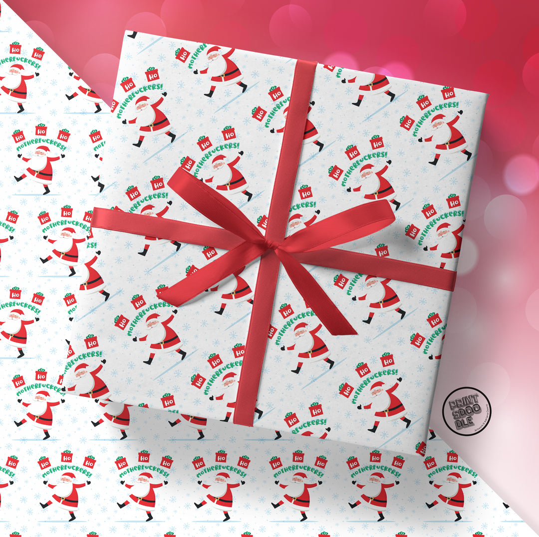 A gift wrapped in SALE! Ho Ho Ho Motherfuckers! (Folded Sheet) funny xmas paper, topped with a red ribbon bow, with more of the same festive wrapping featuring bold holiday cheer text in the background.