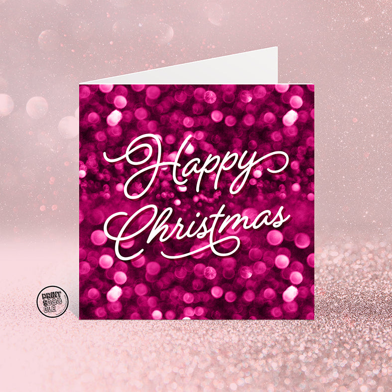 The SALE! Happy Christmas Candy Christmas Card features a sparkling pink bokeh background and "Happy Christmas" in elegant white script. UK printed and packed in a biodegradable bag, it’s a festive eco-friendly choice.