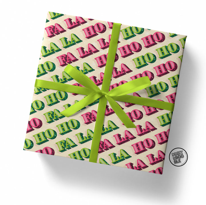 Gift wrapped in vibrant Ho Ho Fa La La Xmas Gift Wrap, featuring colorful text and tied with a bright green ribbon. A small round sticker in the bottom right corner displays "HENRY DOGGLE.