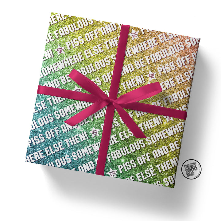 The Piss Off Fabulous Glitter Gift Wrap (Folded Sheet) features a square design with a humorous rainbow gradient and playful text. A vibrant pink ribbon adds extra flair, while amusing phrases like "FABULOUS" and "PISS OFF SOMEWHERE ELSE AND THEN BE FABULOUS SOMEWHERE ELSE" make it ideal for fans of sassy gift wrapping.