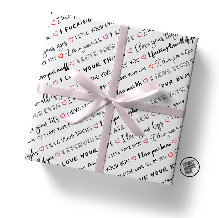 The Tits Gift Wrap (Folded Sheet) is a playful and cheeky gift wrap option featuring affectionate and explicit phrases in black and pink text on white paper. It's tied with a light pink ribbon, complete with a small logo in the bottom right corner, making it an ideal choice for a humorous Valentine’s gift wrap or for celebrating your girlfriend's birthday or wife anniversary.